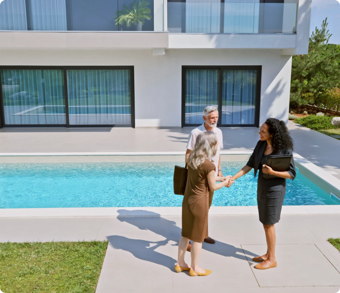 People discussing property near swimming pool