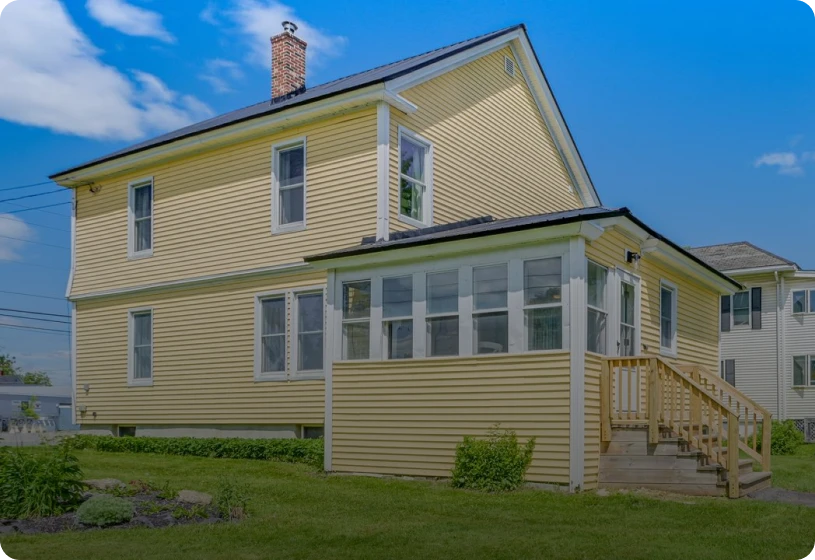 Yellow house with white trim and porch