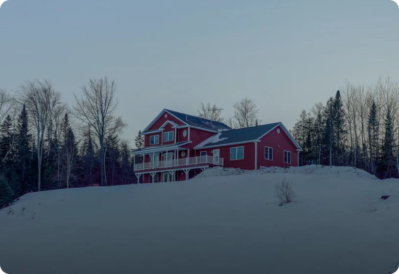 Red house on snowy hill